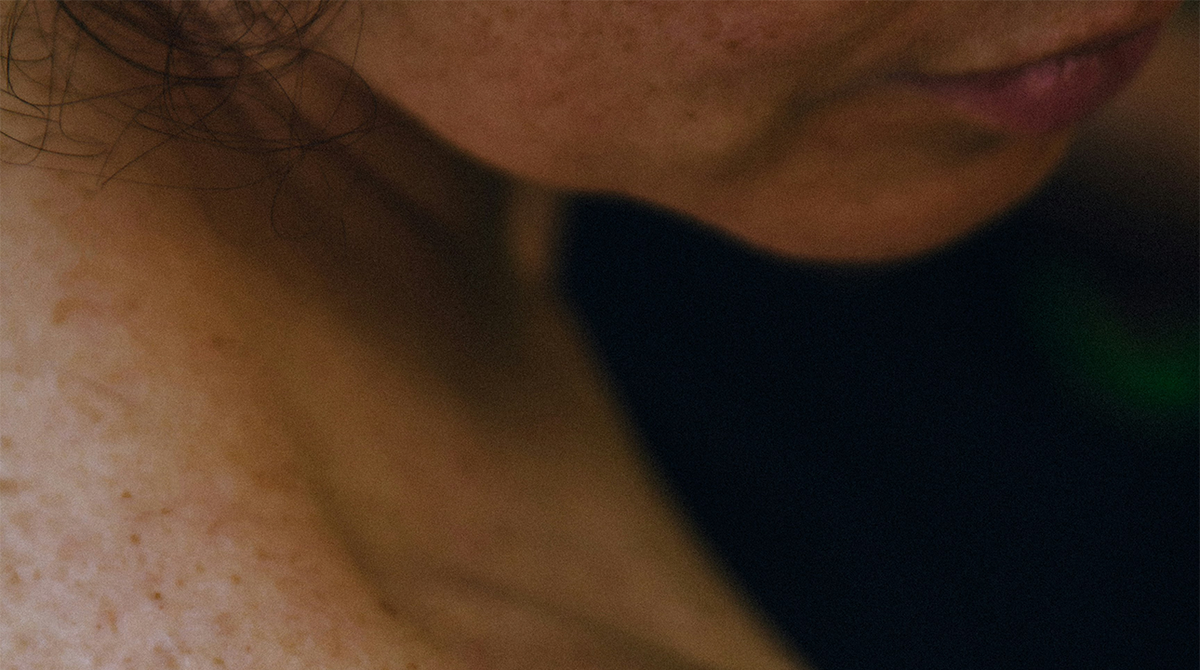 Close-up of a person's neck and shoulder with a blurred background showing how Cirqadian fragrance layers absorb into skin.
